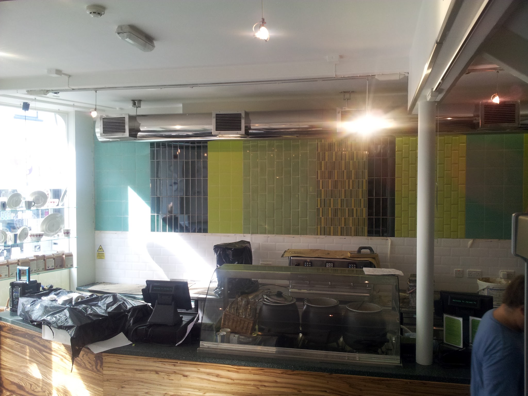 The completed project viewed from the main service area. The combination of colours, textures and laying patterns creates a distinctive feature while complementing the café’s contemporary interior.