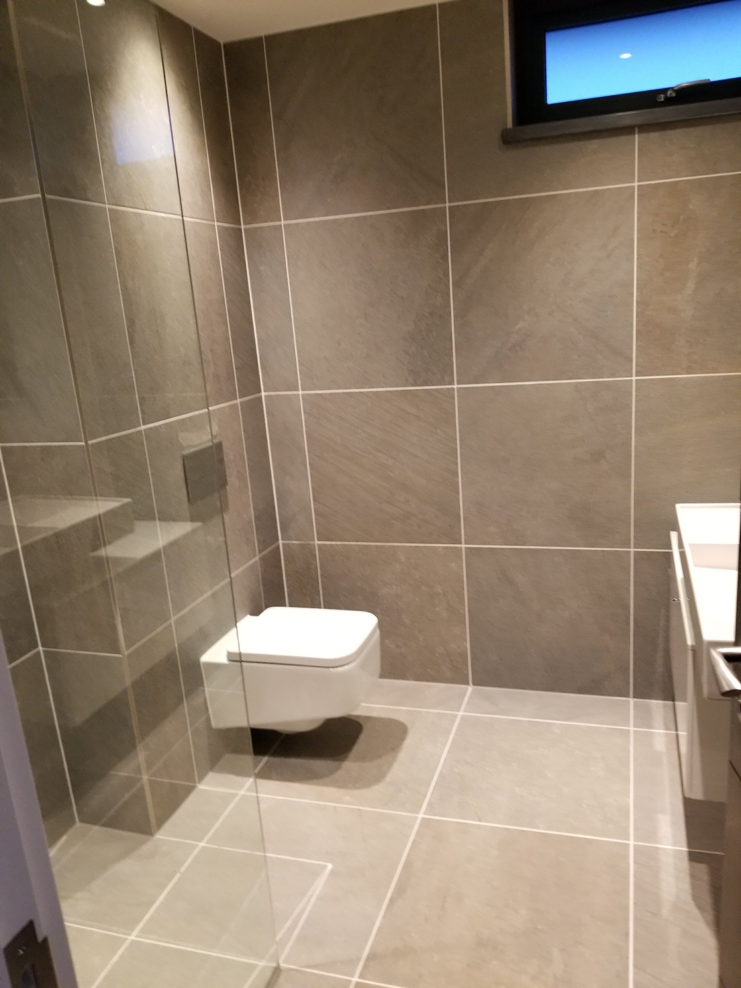The wall-hung toilet and concealed cistern maintain the bathroom’s clean lines and make the floor easier to maintain.