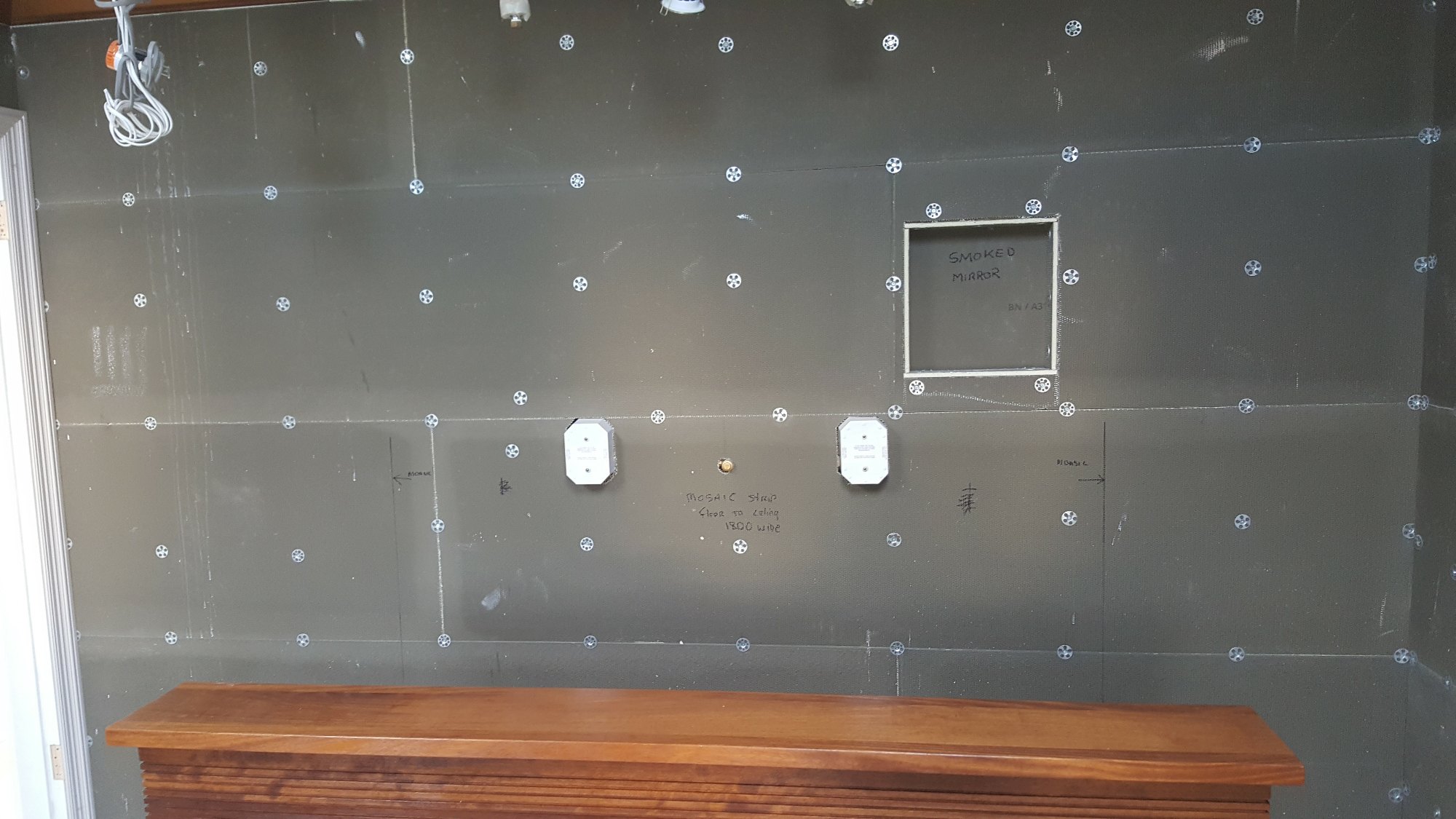 The bathroom walls were fully boarded, with plumbing and electrical connection points precisely positioned for the new fittings.