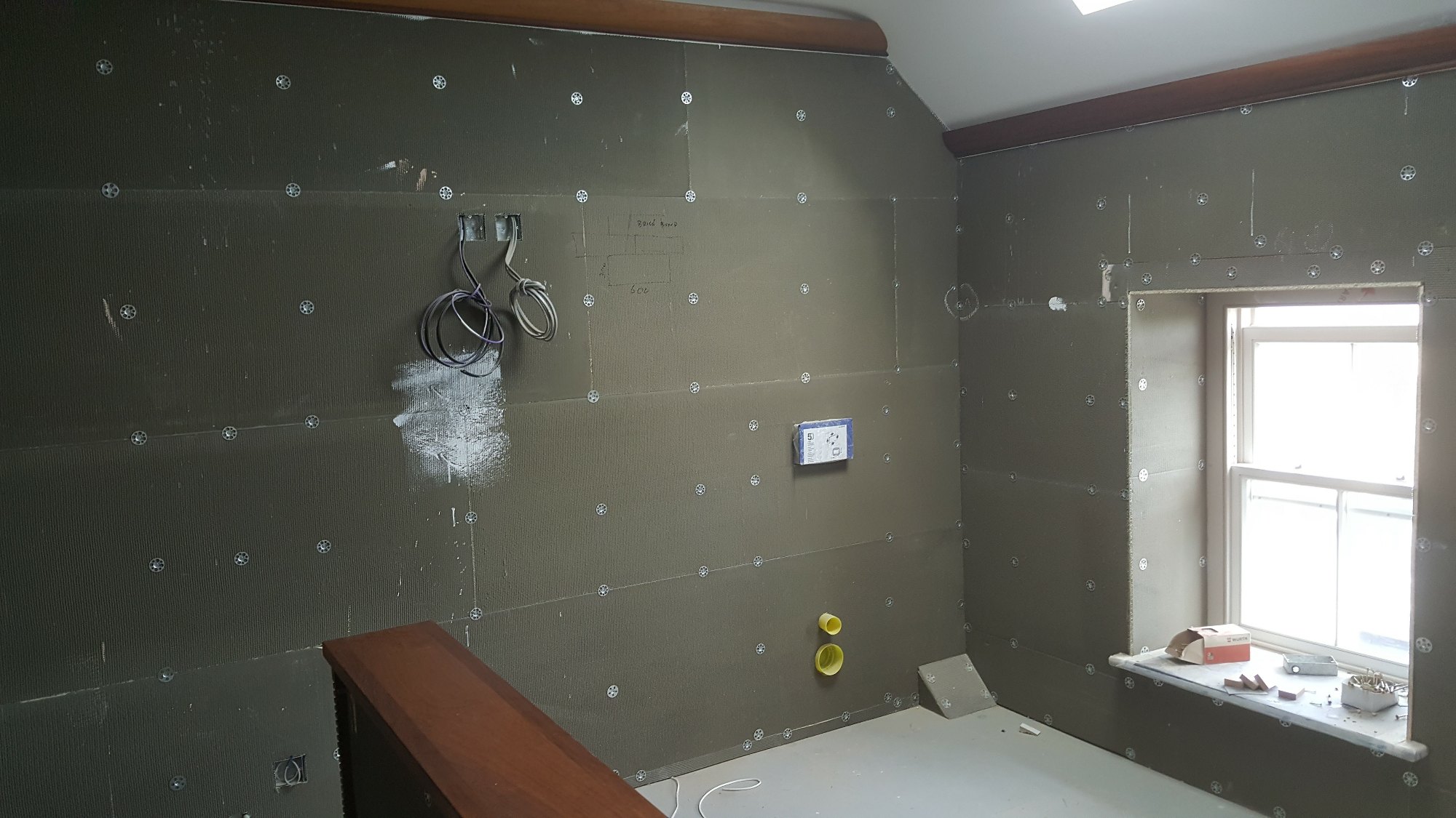 Moisture-resistant boards were fitted and secured around the windows and throughout the bathroom.