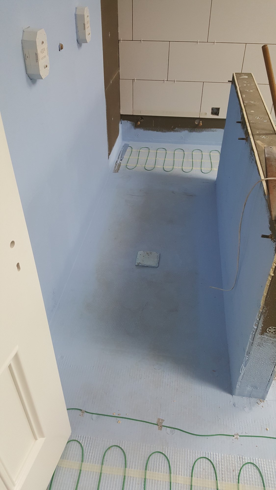 A waterproof membrane was applied to the floor and surrounding areas of the future walk-in shower.