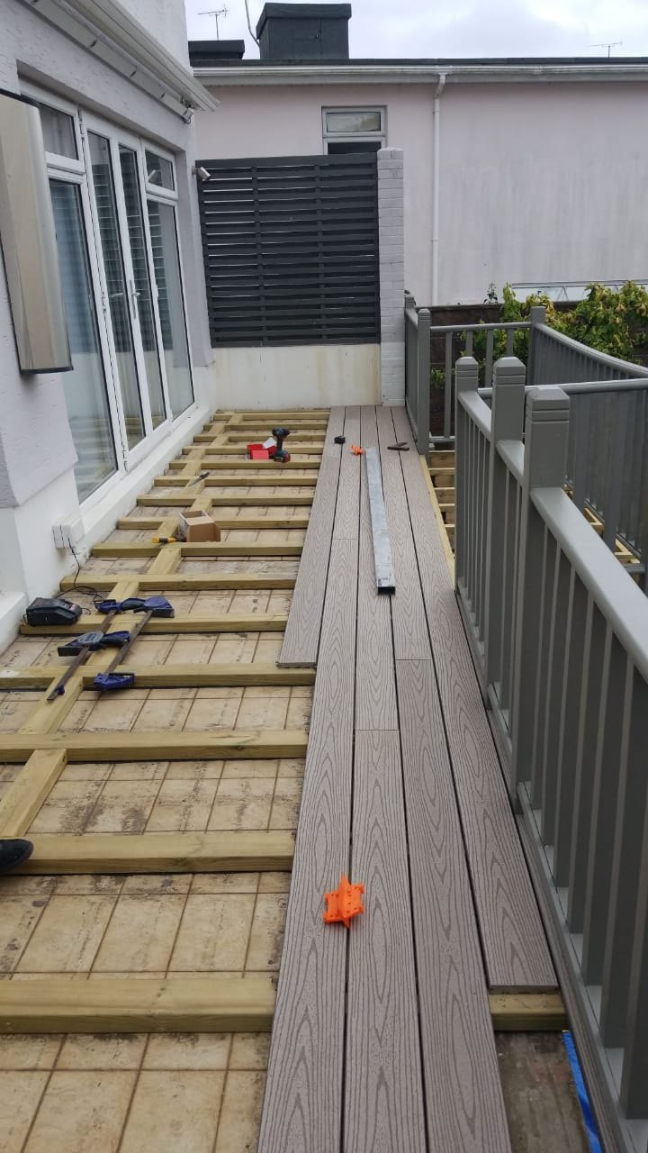 Installation of composite decking The new composite deck boards were carefully aligned and secured to the timber subframe.
