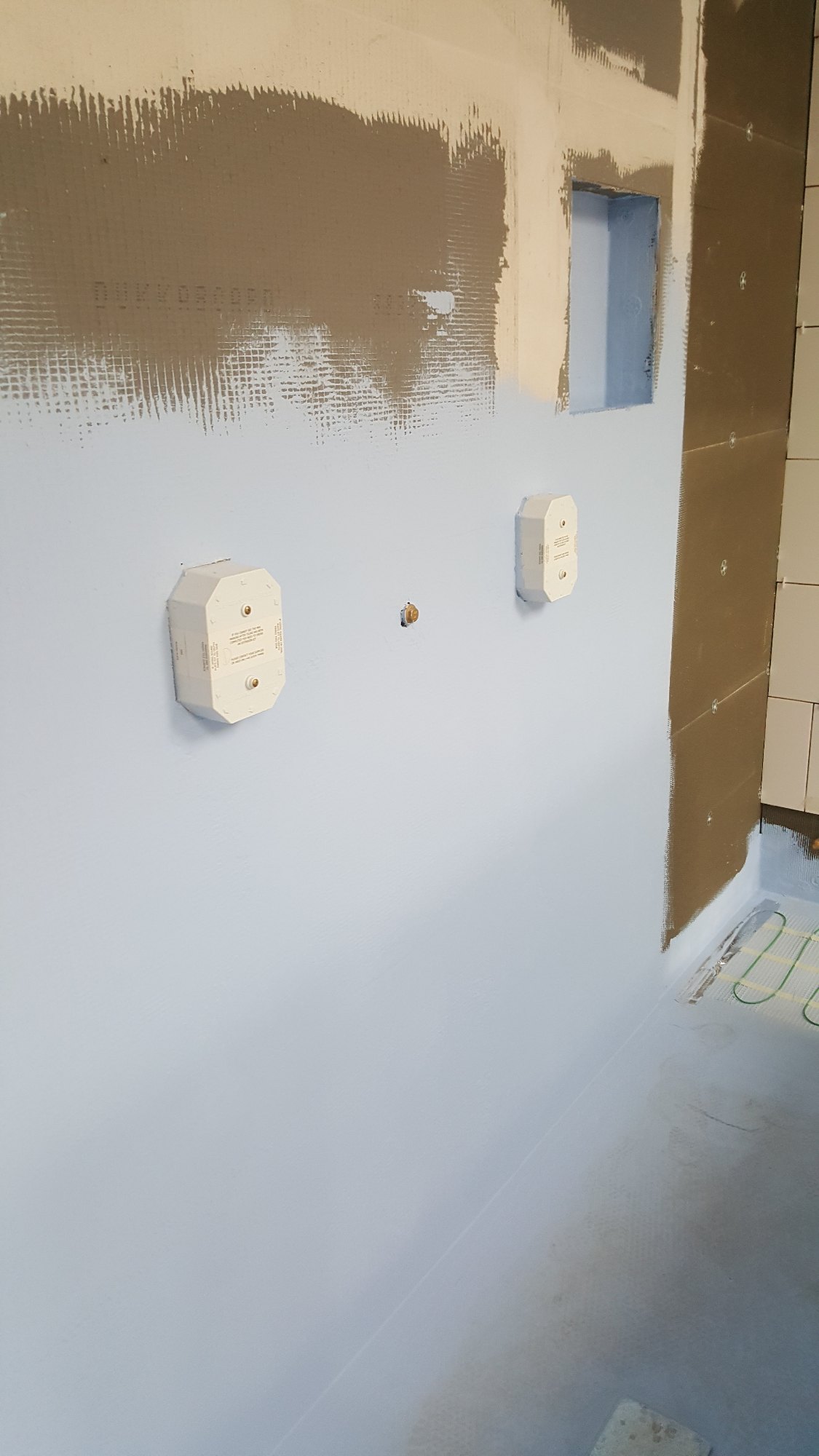 The shower wall and floor were fully sealed to create a durable, water-resistant foundation beneath the tiles.
