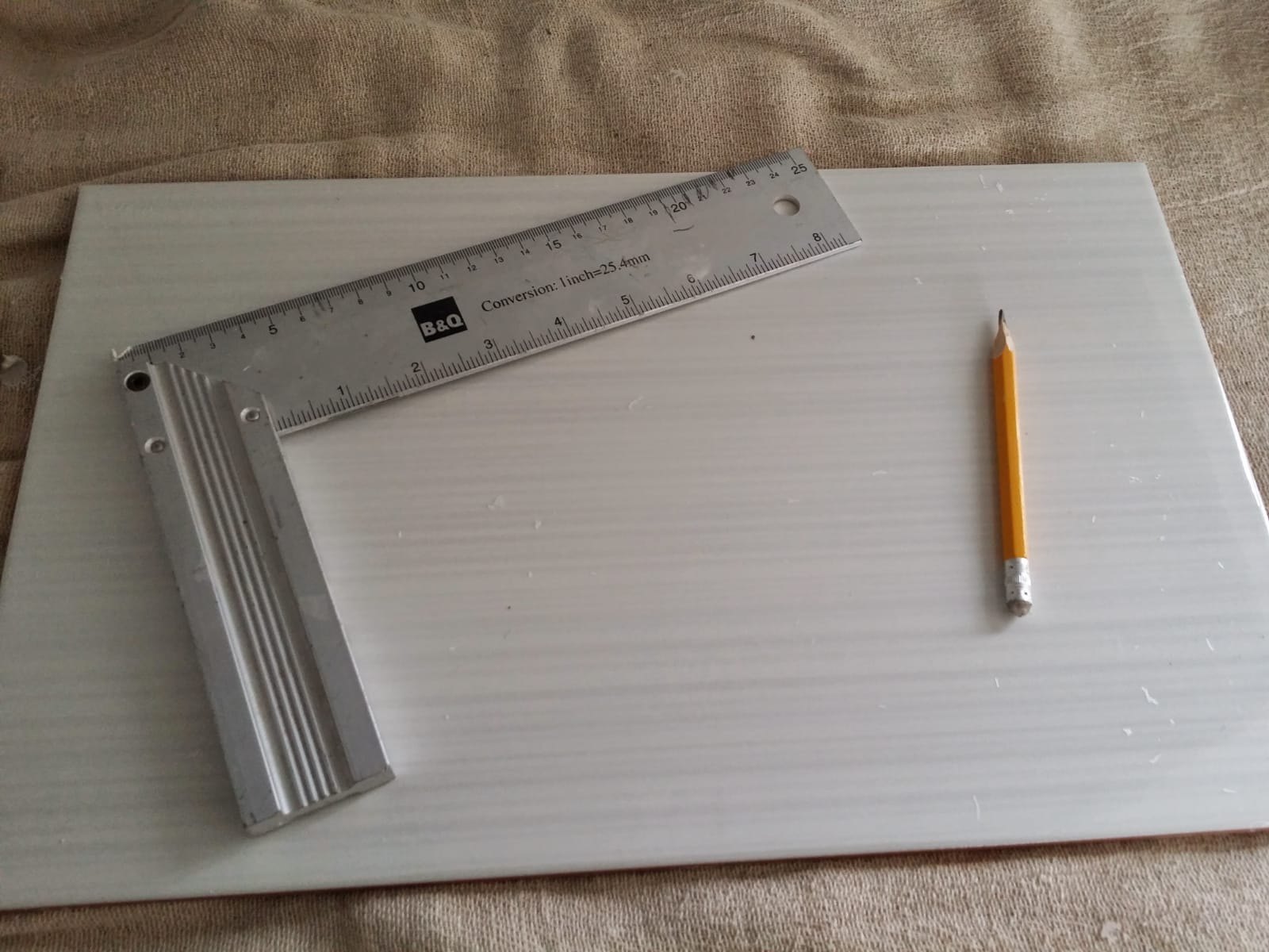 The tile was carefully measured and marked before cutting to ensure an accurate fit around the existing kitchen features.