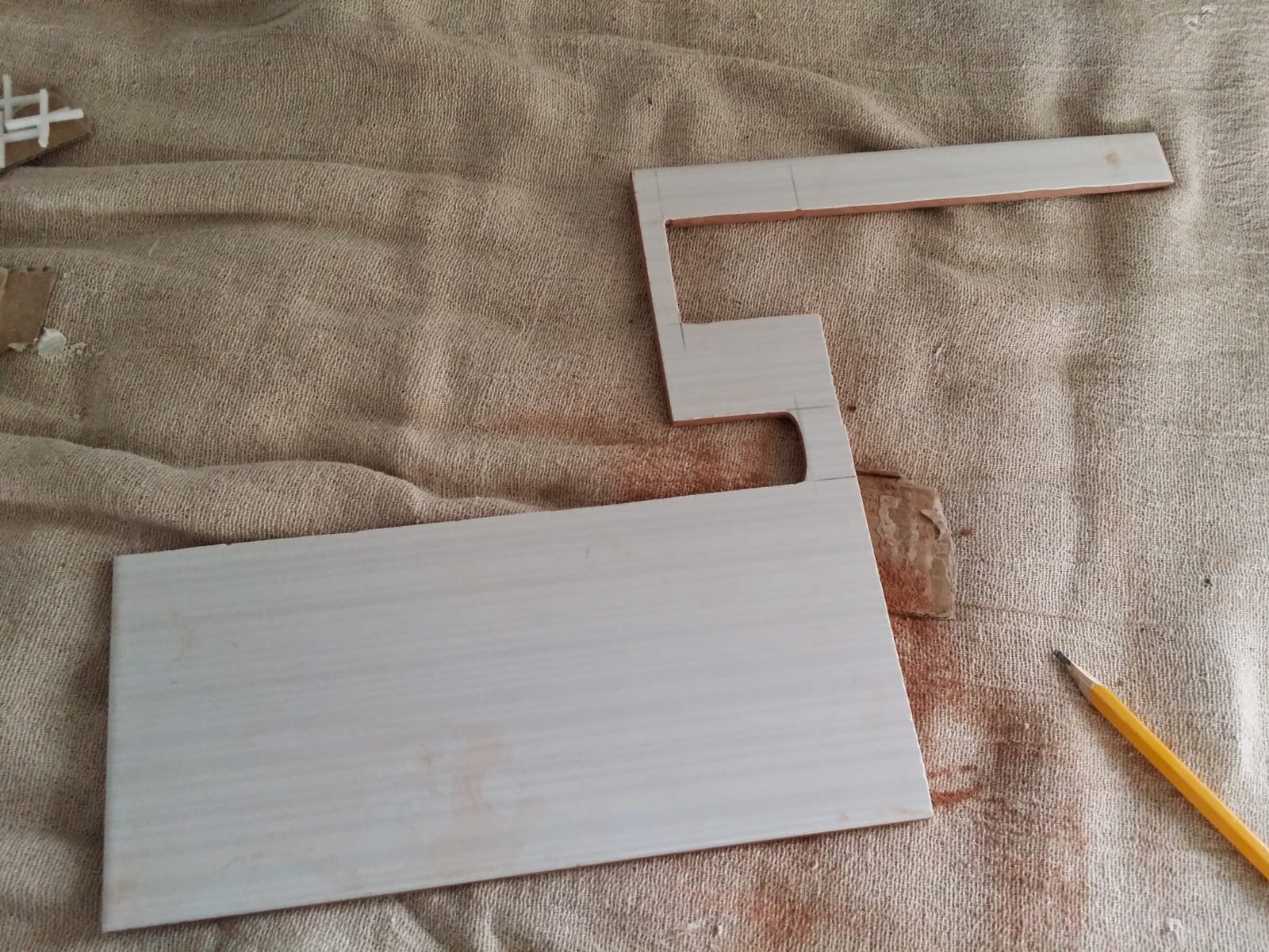 A complex tile shape was cut to follow the exact profile of the worktop, corner and surrounding surfaces.